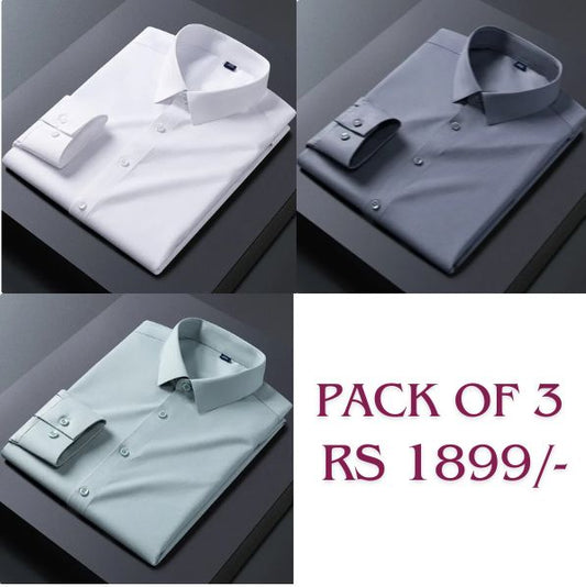 Three folded cotton shirts in white, dark grey, and pink colors, displayed on a flat surface, with the text 'PACK OF 3' and 'Rs 1899' on the bottom right corner.