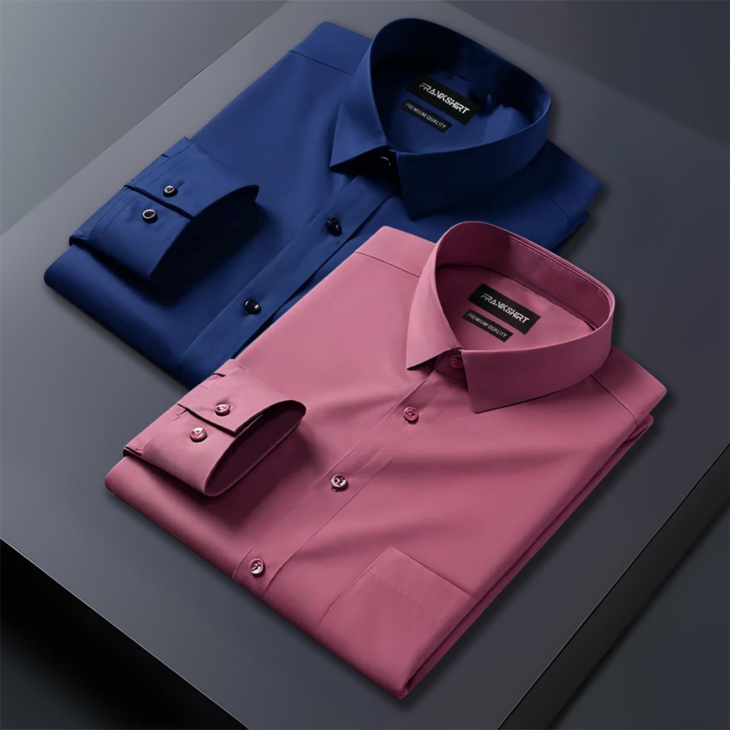 Folded blue and pink dress shirts on a gray surface