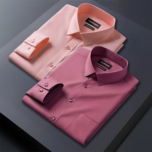 Two folded dress shirts, one pink and one purple, on a dark surface.